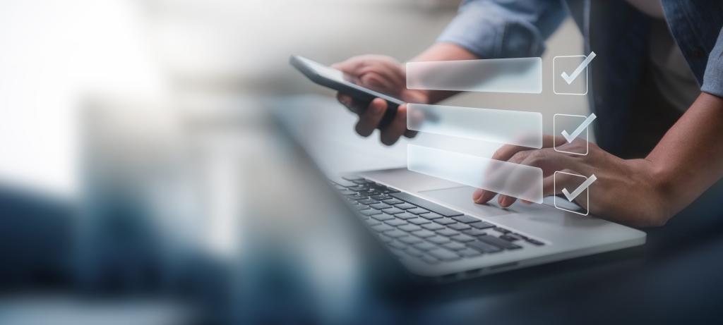 person using a laptop with digital checklist icon for online form concept